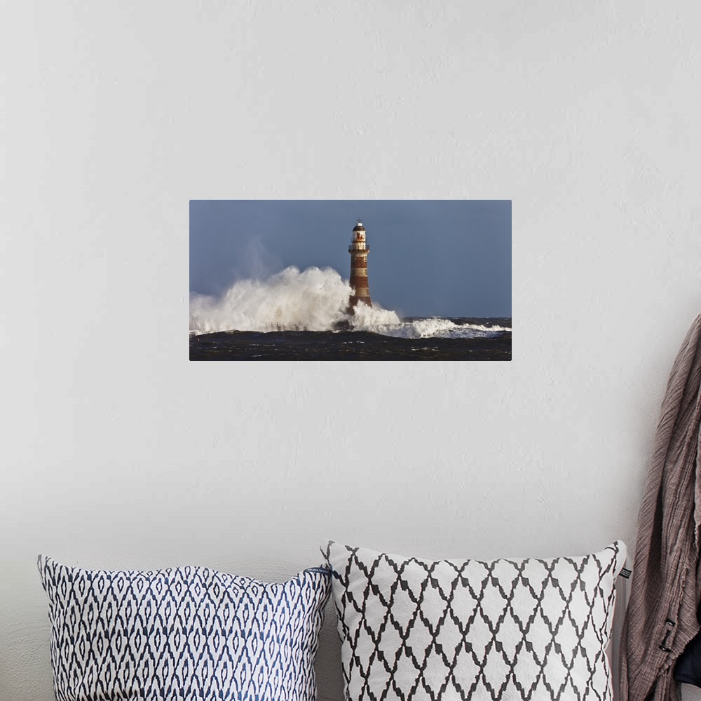 A bohemian room featuring Waves Crashing Against A Lighthouse; Sunderland, Tyne And Wear, England