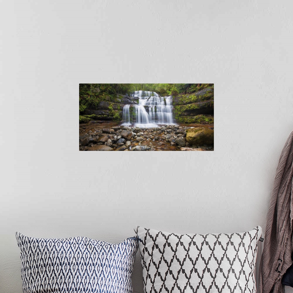 A bohemian room featuring A photograph of a multi-leveled waterfalls
