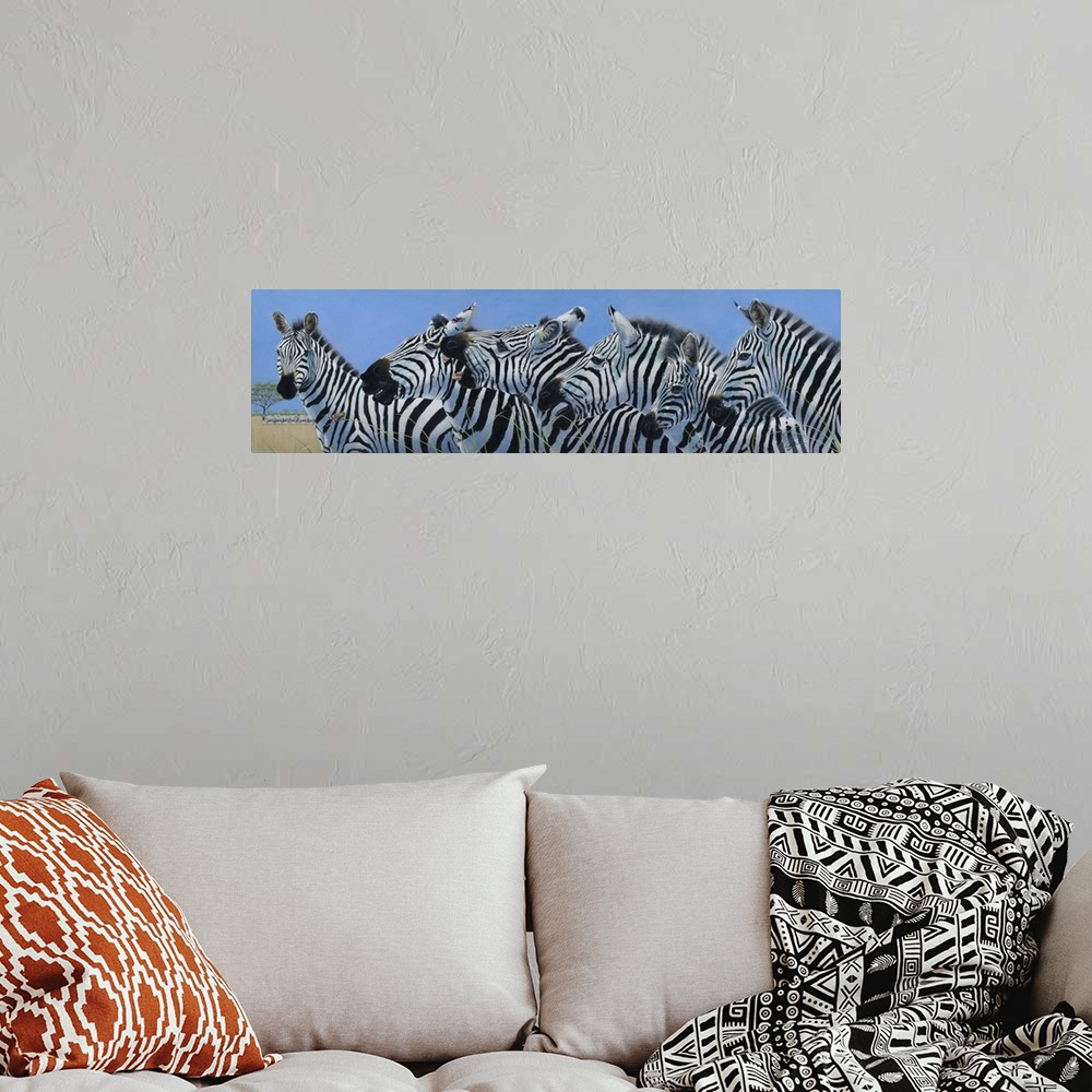 A bohemian room featuring Contemporary painting of a herd of zebras.