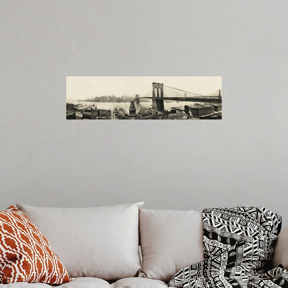 A bohemian room featuring A vintage photograph of a the Brooklyn bridge spanning the East River toward Manhattan.