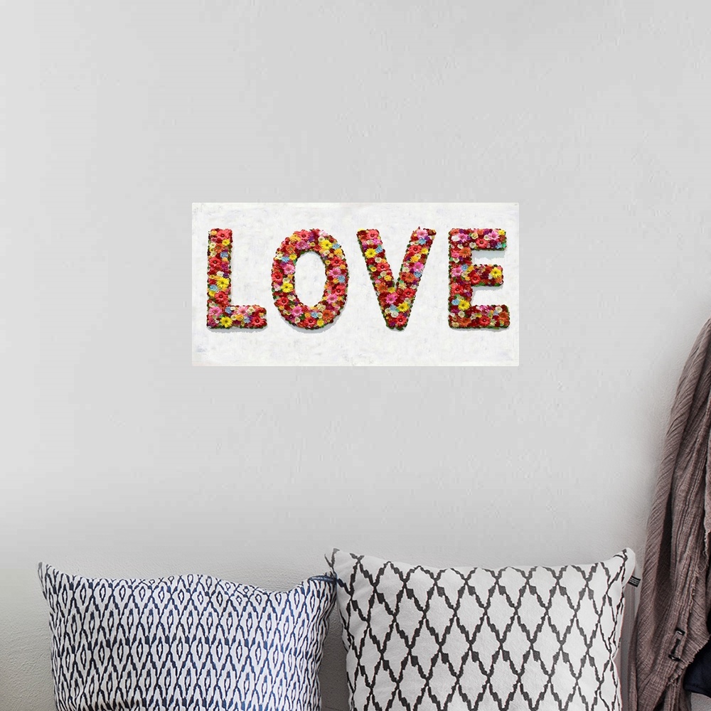 A bohemian room featuring The word love is shaped by an assortment of colorful flowers.