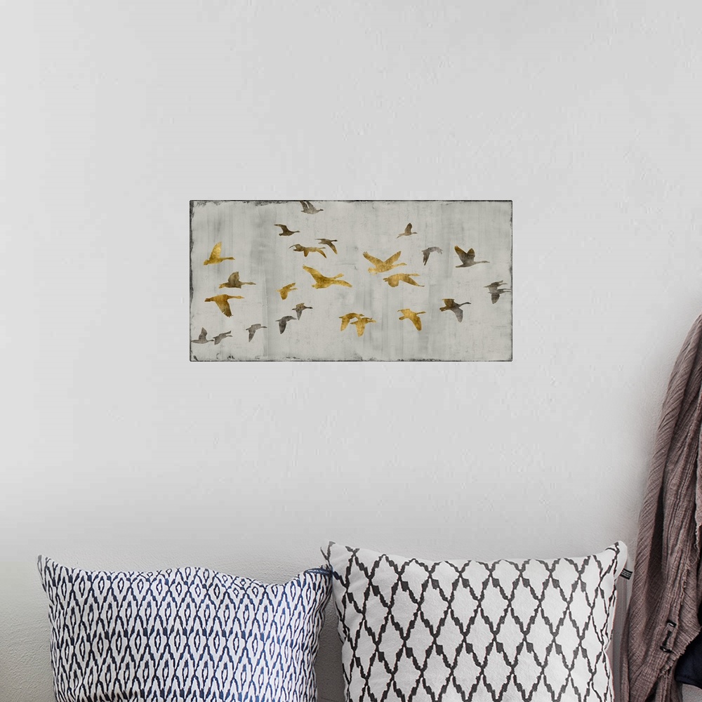 A bohemian room featuring Large decor with gold and silver birds in flight on a silver textured background.