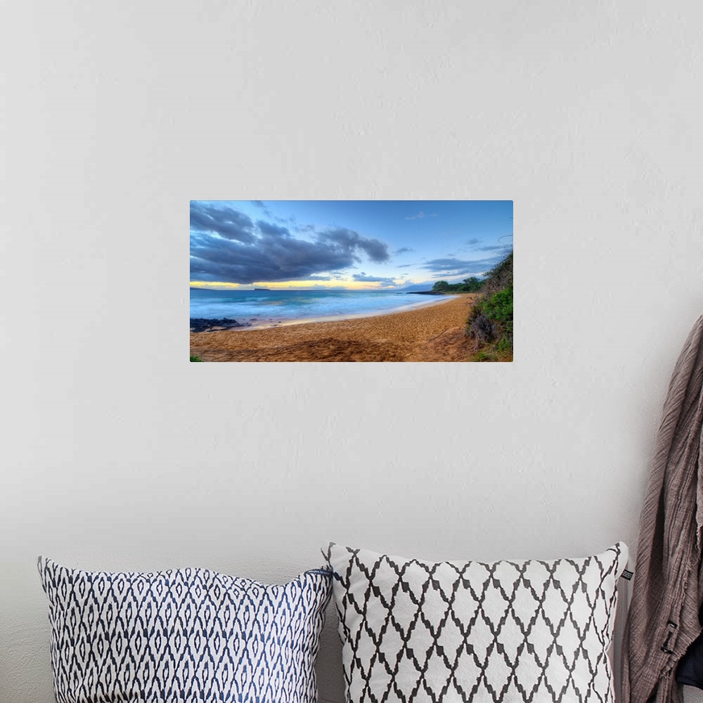A bohemian room featuring Landscape photograph of an empty beach in Maui.