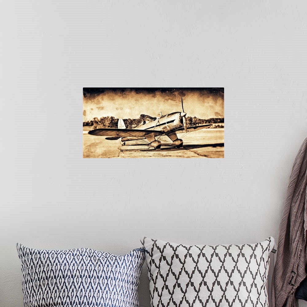 A bohemian room featuring A distressed photograph of an antique airplane.
