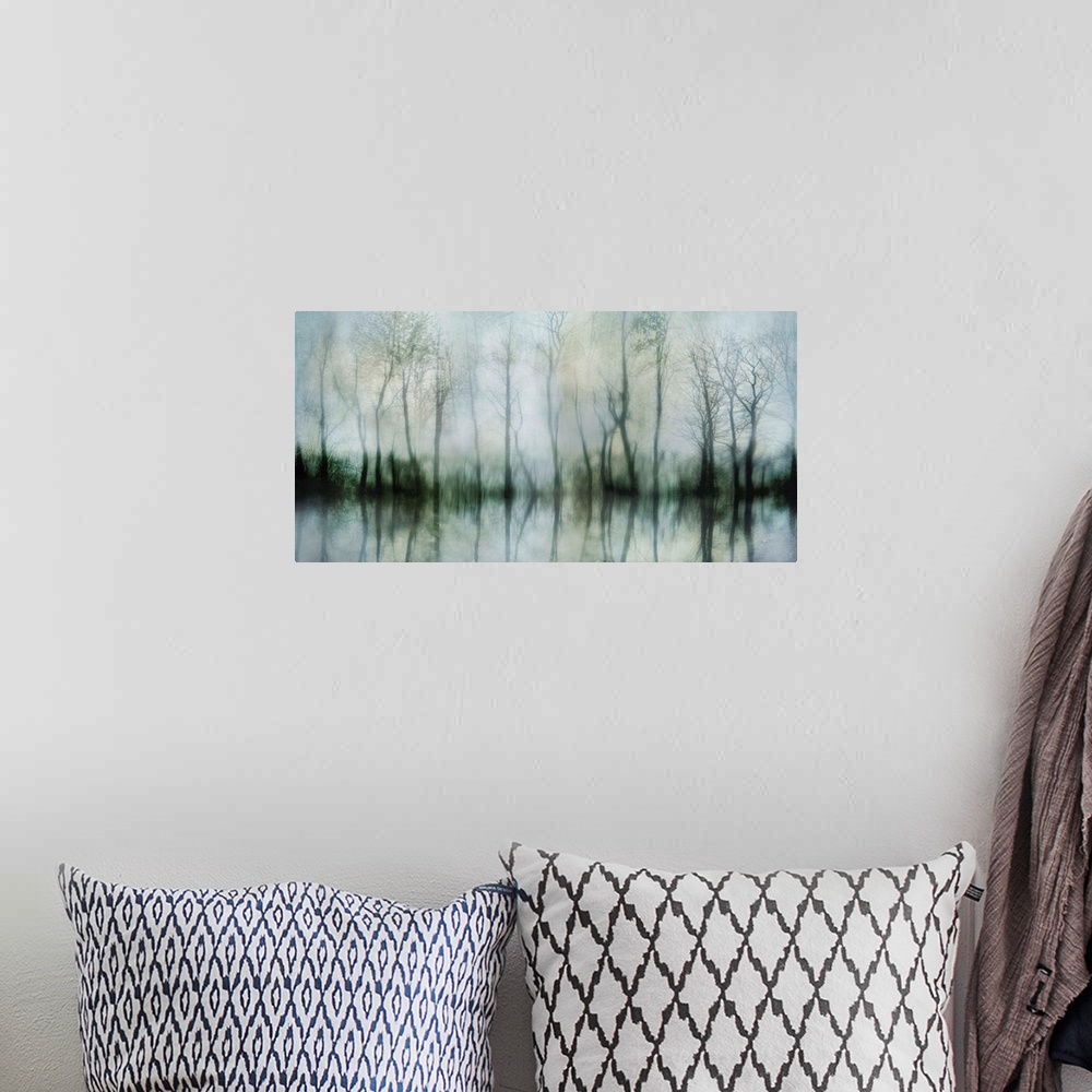 A bohemian room featuring Contemporary artwork of shadowy bare trees at the edge of a pond.