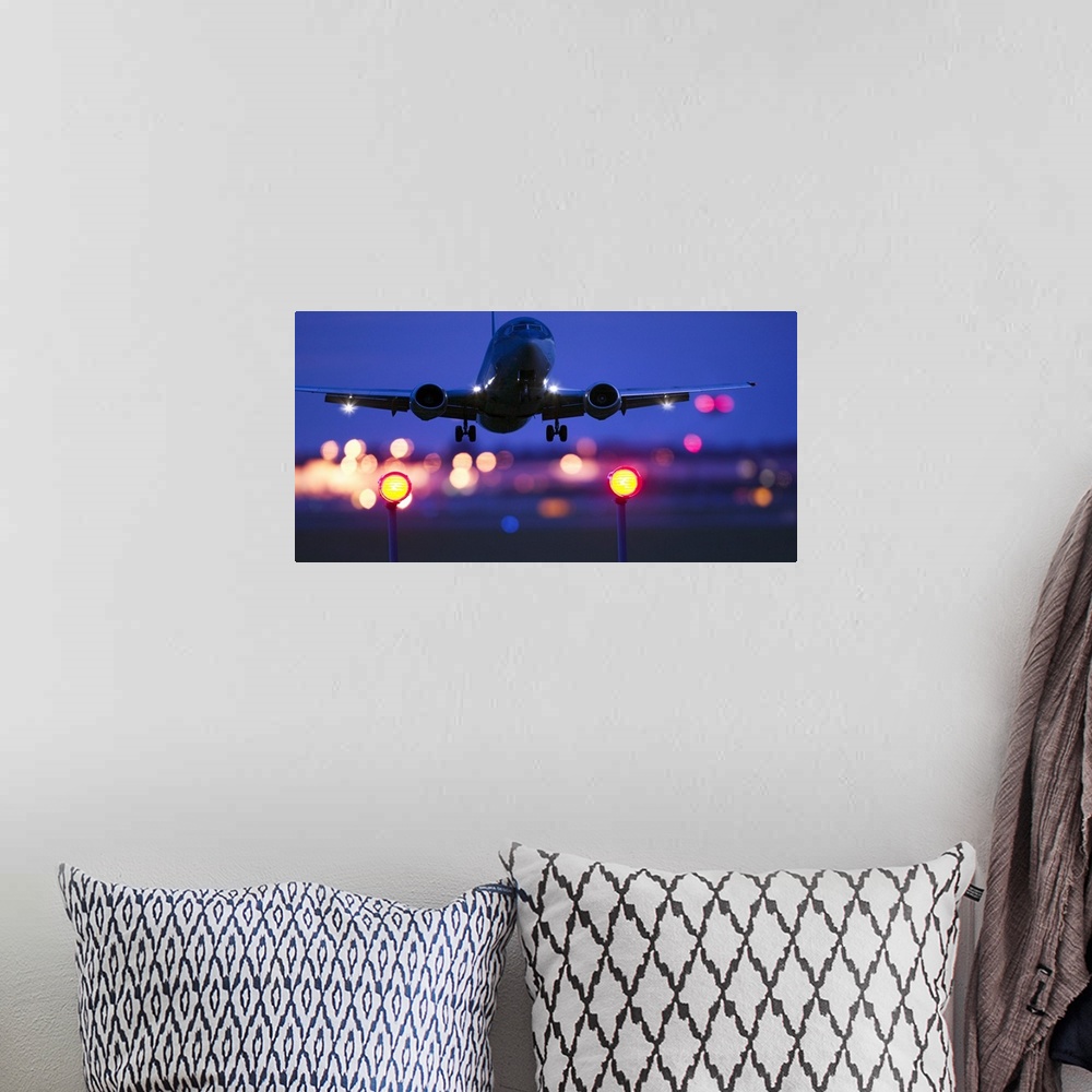 A bohemian room featuring Composite close-up of an airplane landing with blurred lights of the airport in the background