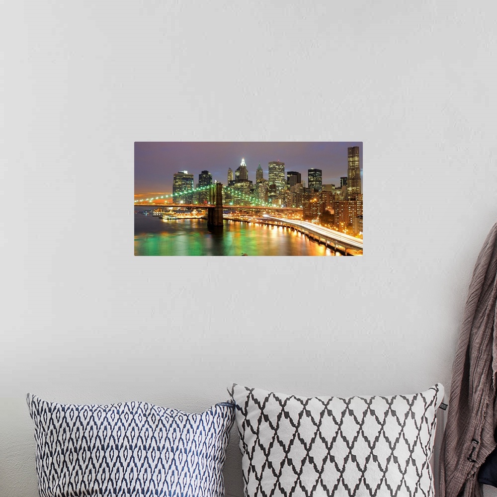 A bohemian room featuring Oversized, horizontal photograph of bright lights of the Brooklyn Bridge and New York City, at ni...