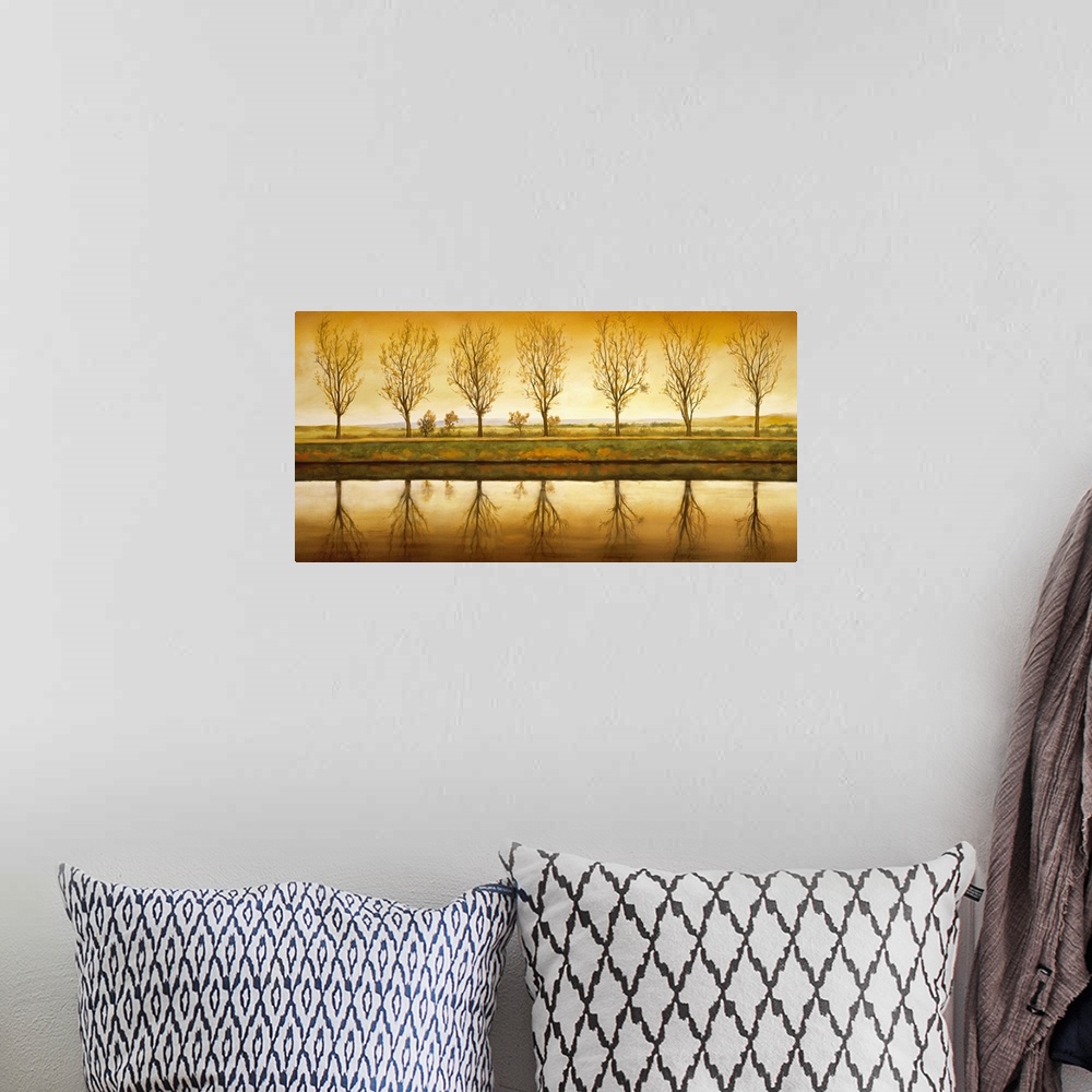 A bohemian room featuring Contemporary art on a landscape canvas of a line of seven trees with nearly bare branches, reflec...