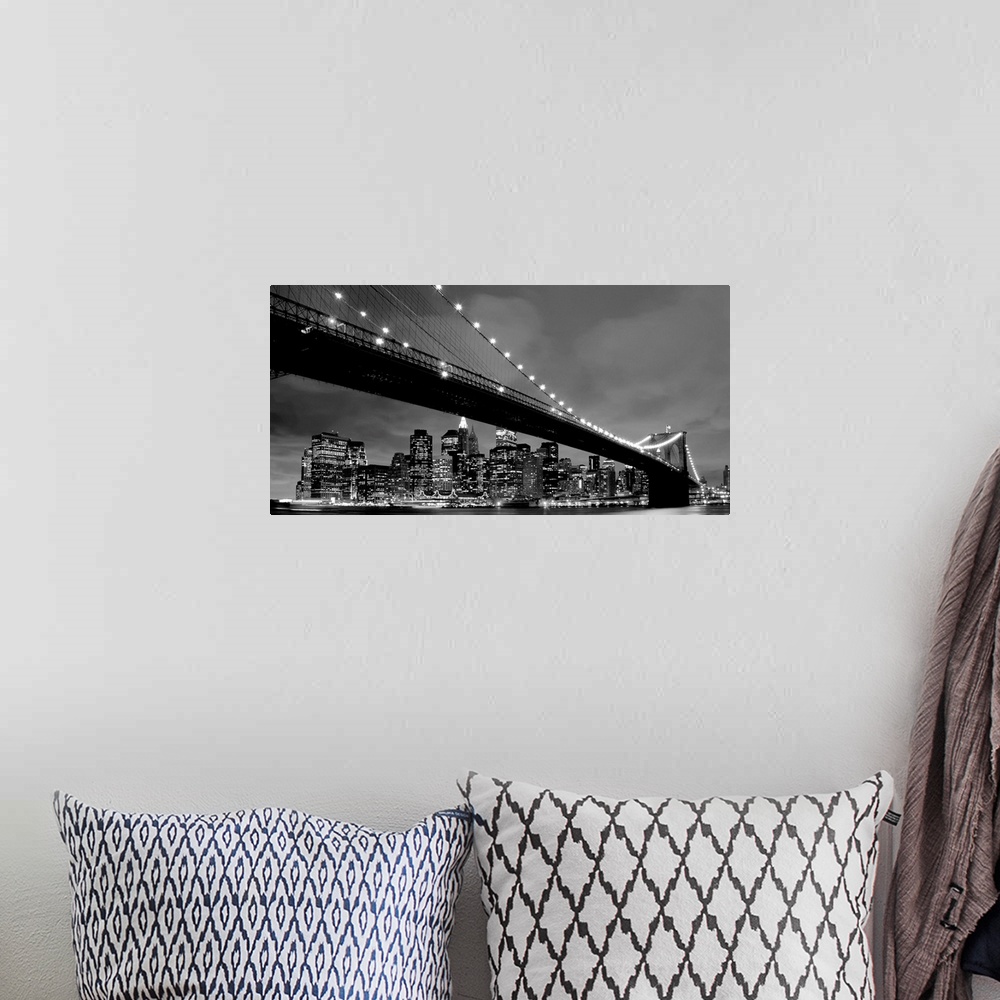 A bohemian room featuring Black and white panoramic of the Brooklyn Bridge with New York City in the background.