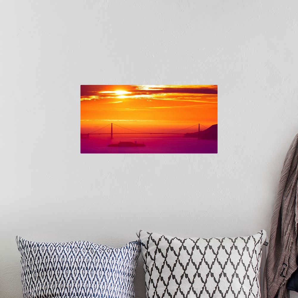 A bohemian room featuring A photograph of a vibrant sky at sunrise, with a bridge in hazy, misty morning light.