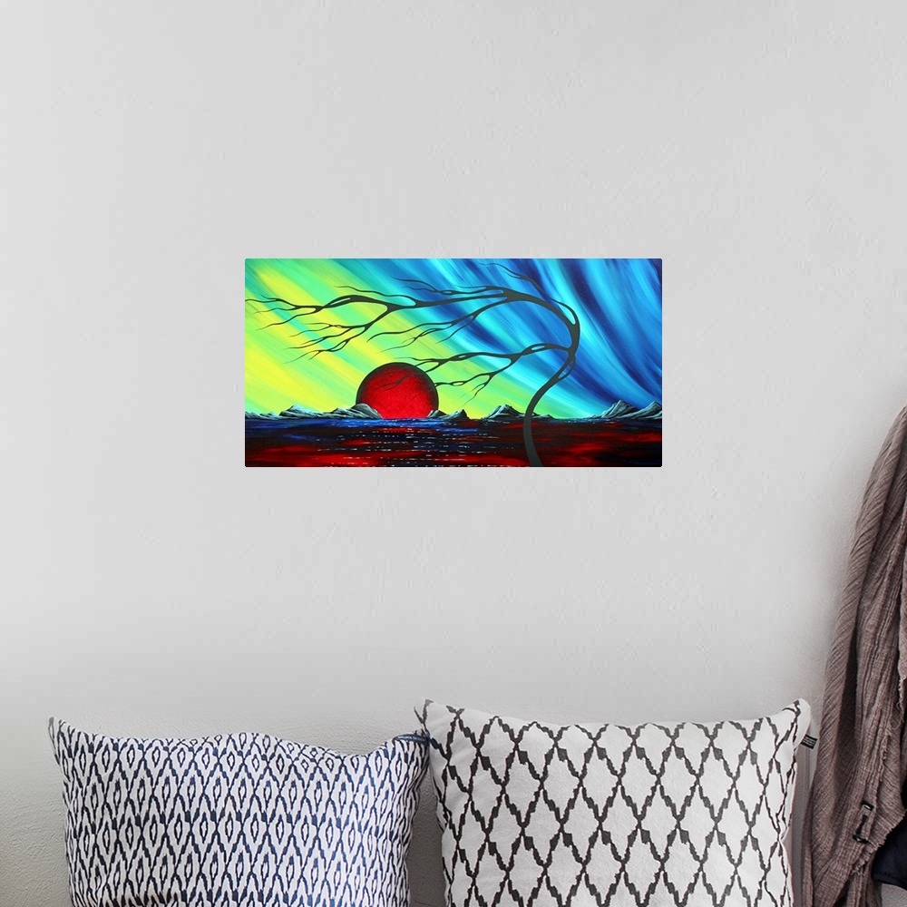 A bohemian room featuring Abstract artwork of a deep red sun that sits on the horizon with a cool colored sky above it. A f...