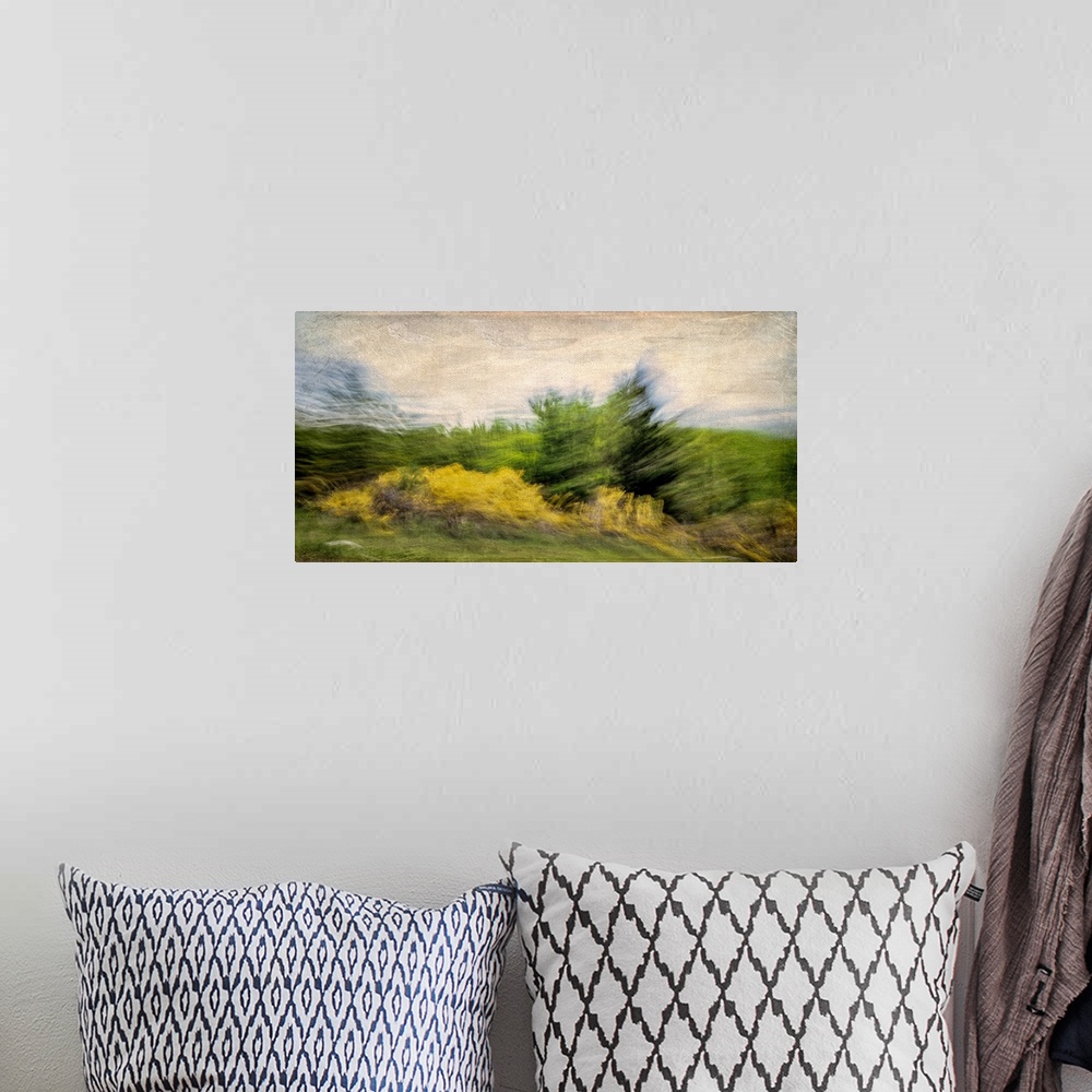 A bohemian room featuring A turbulent scene of the wind stirring up the trees and clouds.