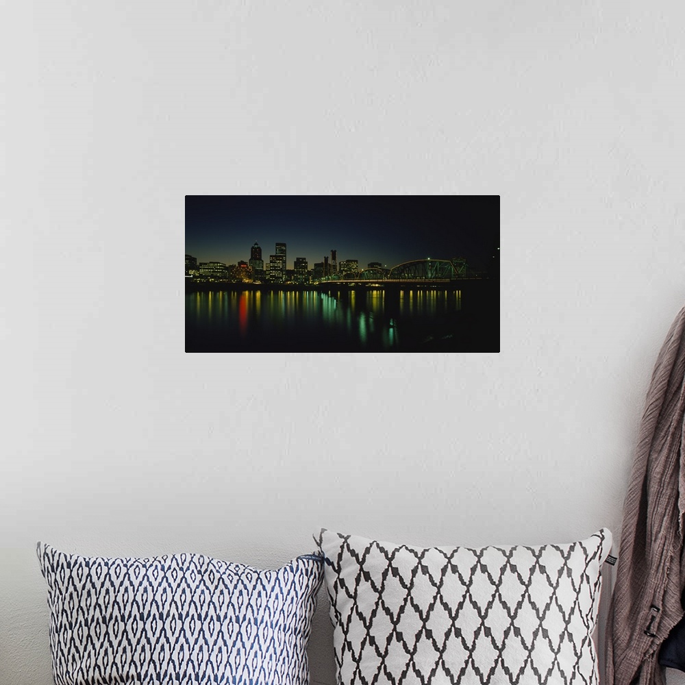 A bohemian room featuring Panoramic photograph taken of a busy city in the Northwestern United States during nighttime.  Th...