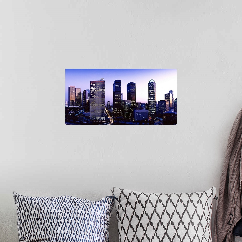 A bohemian room featuring Panoramic photograph of cityscape at sunset with buildings lit up.