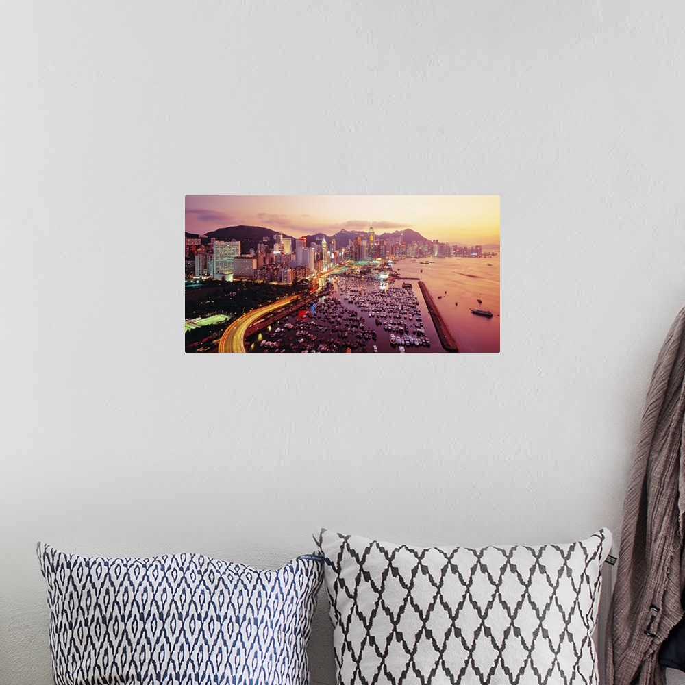 A bohemian room featuring Large photograph of a harbor in Hong Kong at sunset. Hundreds of boats and many buildings can be ...