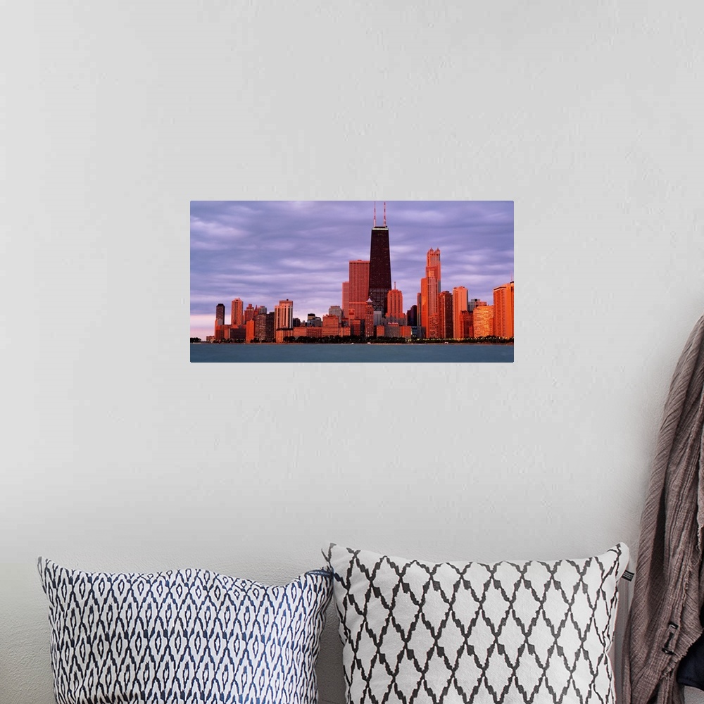 A bohemian room featuring This landscape wall art captures the city skyline from the lake in the fading sunlight of the eve...