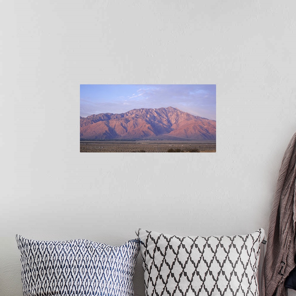 A bohemian room featuring Wide angle picture of San Jacinto Peak in California. The sun is setting out of view and shining ...