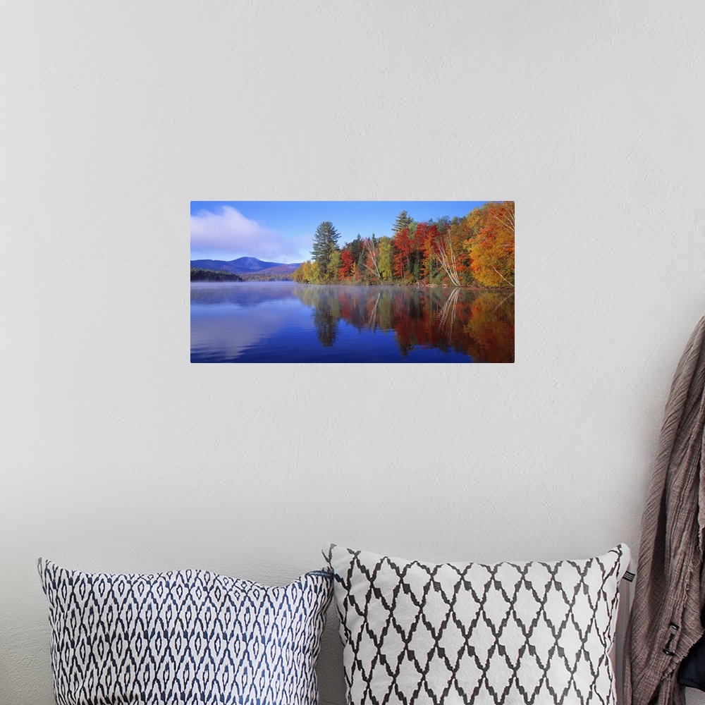 A bohemian room featuring Big, horizontal photograph of autumn trees reflecting along the shoreline of the Franklin Falls P...