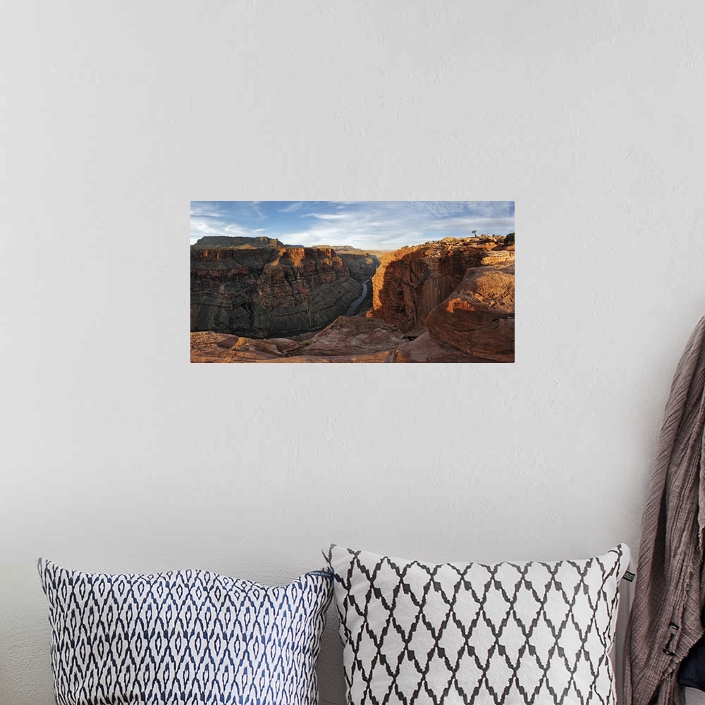 A bohemian room featuring Large canvas photo of Grand Canyon cliffs draped in sunlight and shadows with a river running thr...