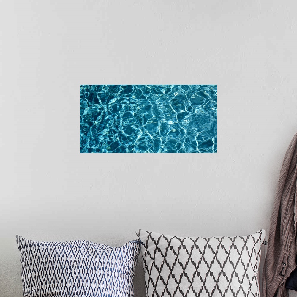 A bohemian room featuring Panoramic photograph of water reflected in the bottom of a pool.