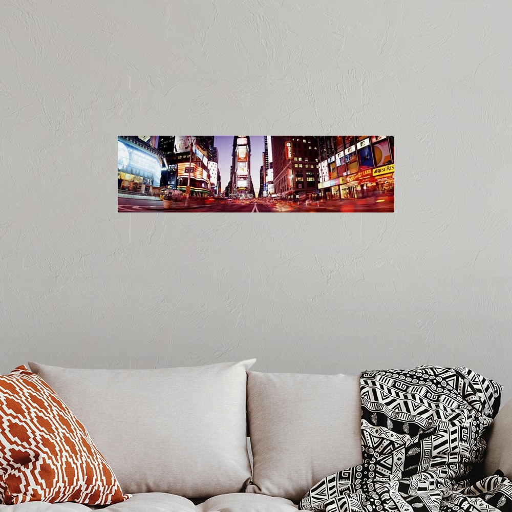 A bohemian room featuring Part of Times Square is photographed in panoramic view while it's illuminated under the dusk sky.