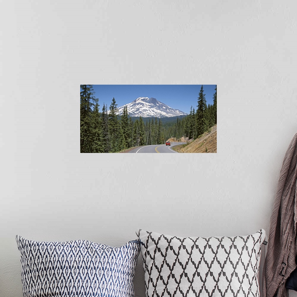 A bohemian room featuring Vehicle moving on a road with South Sister Mountain in background, Oregon