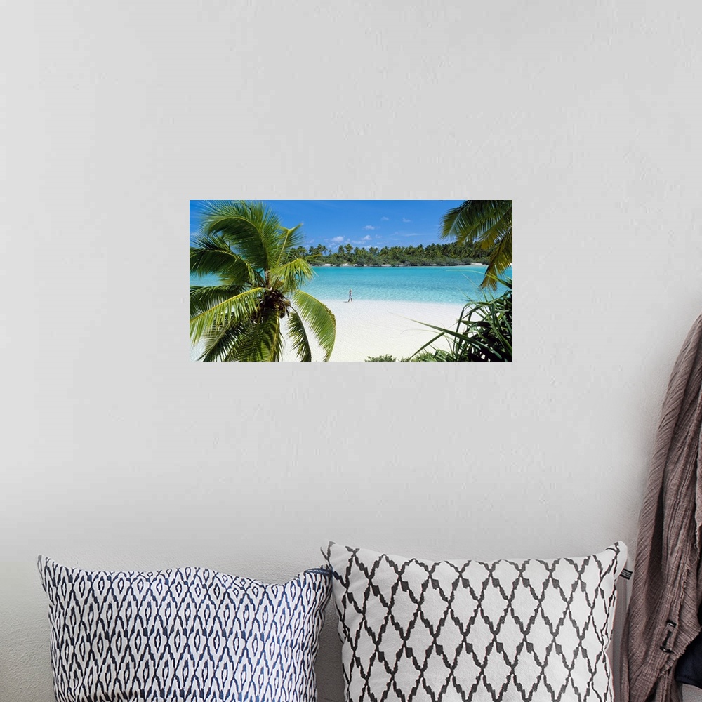 A bohemian room featuring Photograph of a lady walking alone on a white sand beach surrounded by crystal clear water and pa...