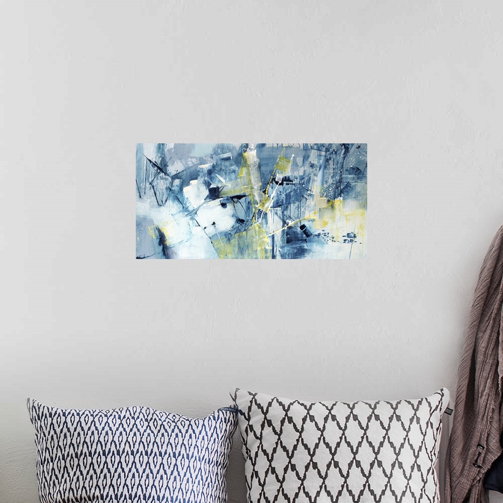 A bohemian room featuring Large abstract painting of textured blue brush strokes with yellow accents.