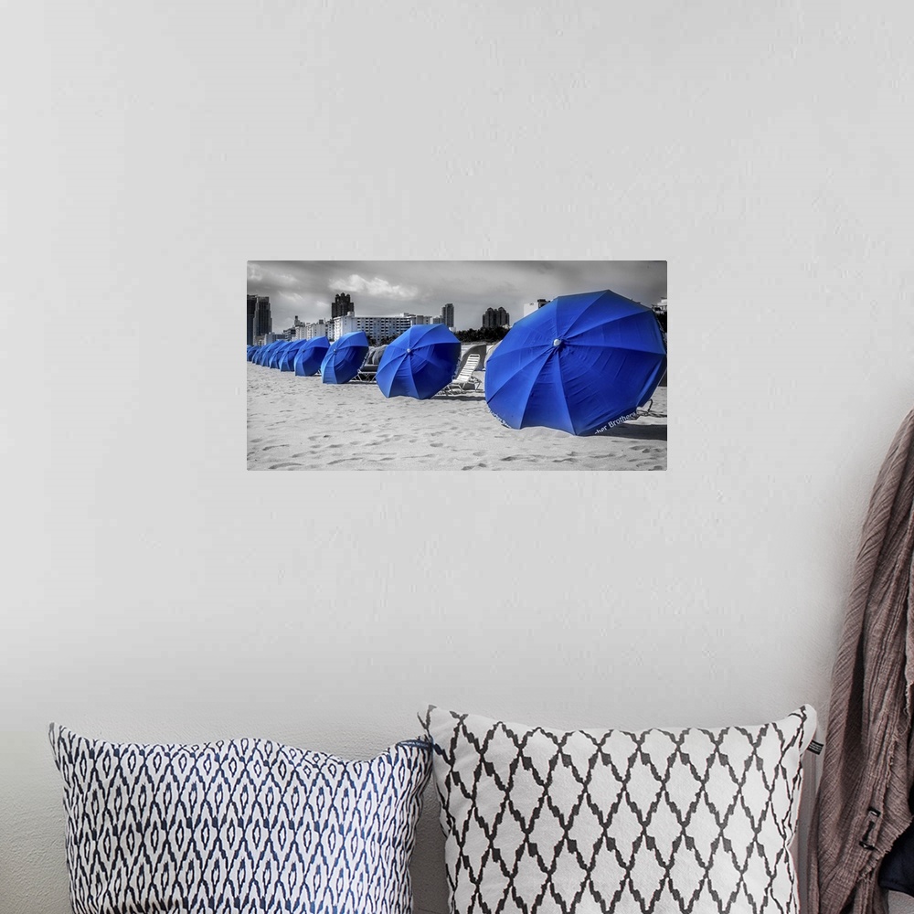 A bohemian room featuring Blue beach umbrellas in the sand at the beach in Miami, Florida.