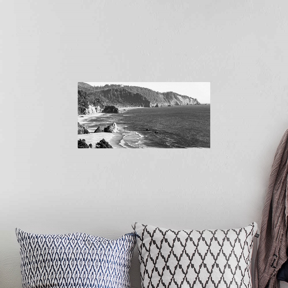 A bohemian room featuring Black and white landscape photograph of the Cannon Beach shore in Oregon.