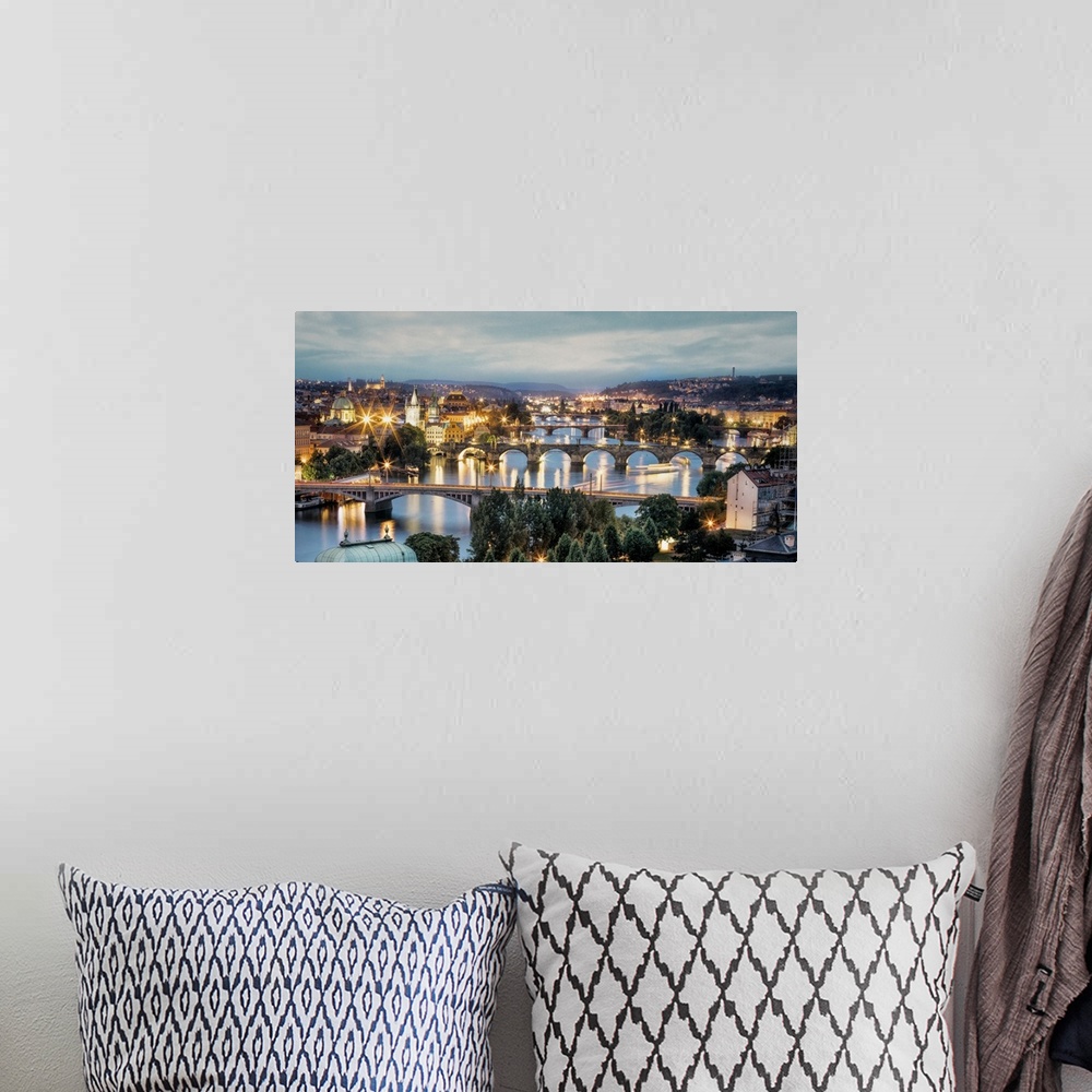 A bohemian room featuring Panorama of Vltava River and bridges in Prague at sunset.