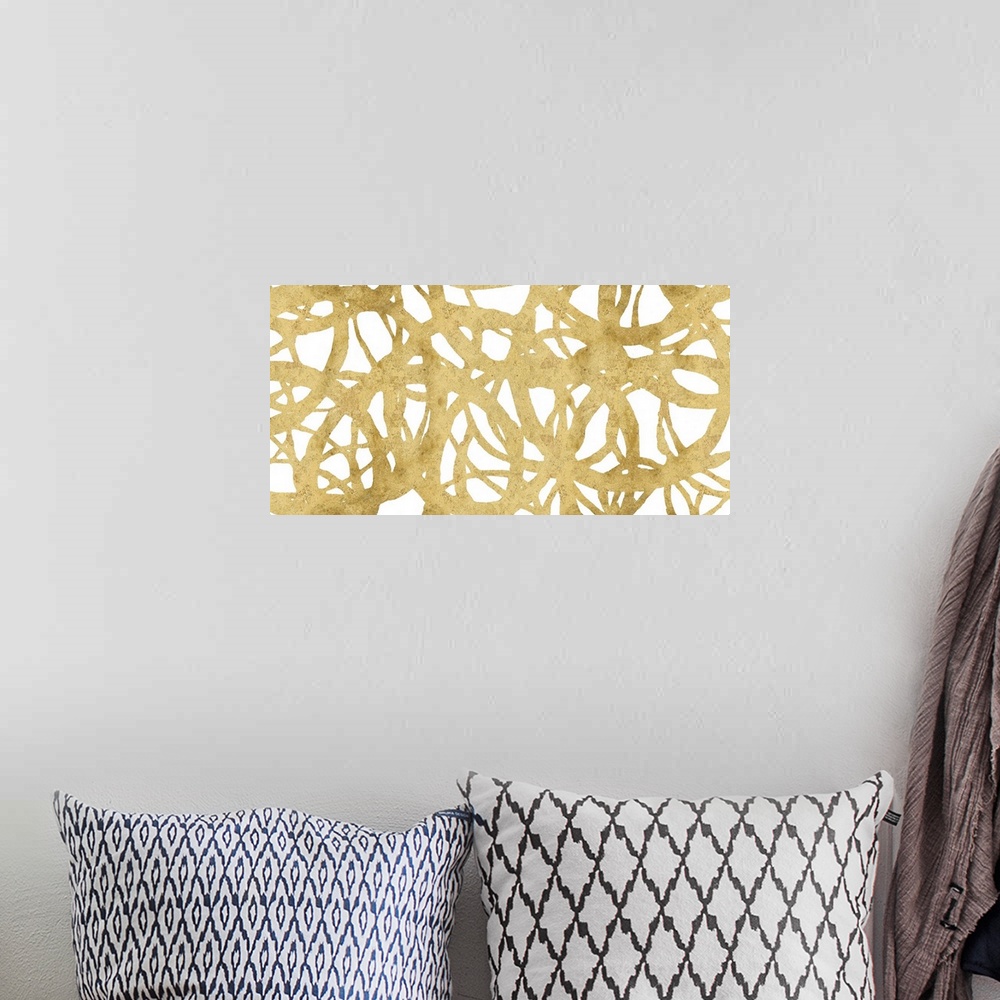 A bohemian room featuring Large abstract painting with a golden web-like design on a white background.