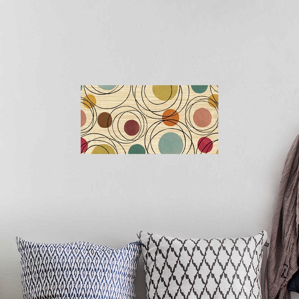 A bohemian room featuring Whimsical abstract painting of several different-colored circles and black rings on a neutral bac...