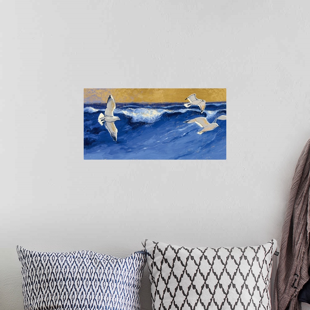 A bohemian room featuring A contemporary painting of seagulls in flight over a choppy blue sea.