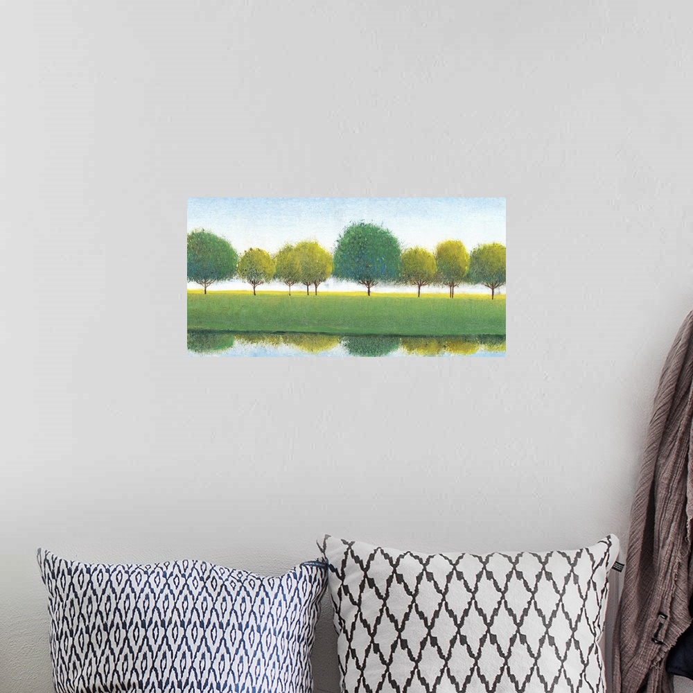 A bohemian room featuring Painting of a row of trees reflected in the river below.
