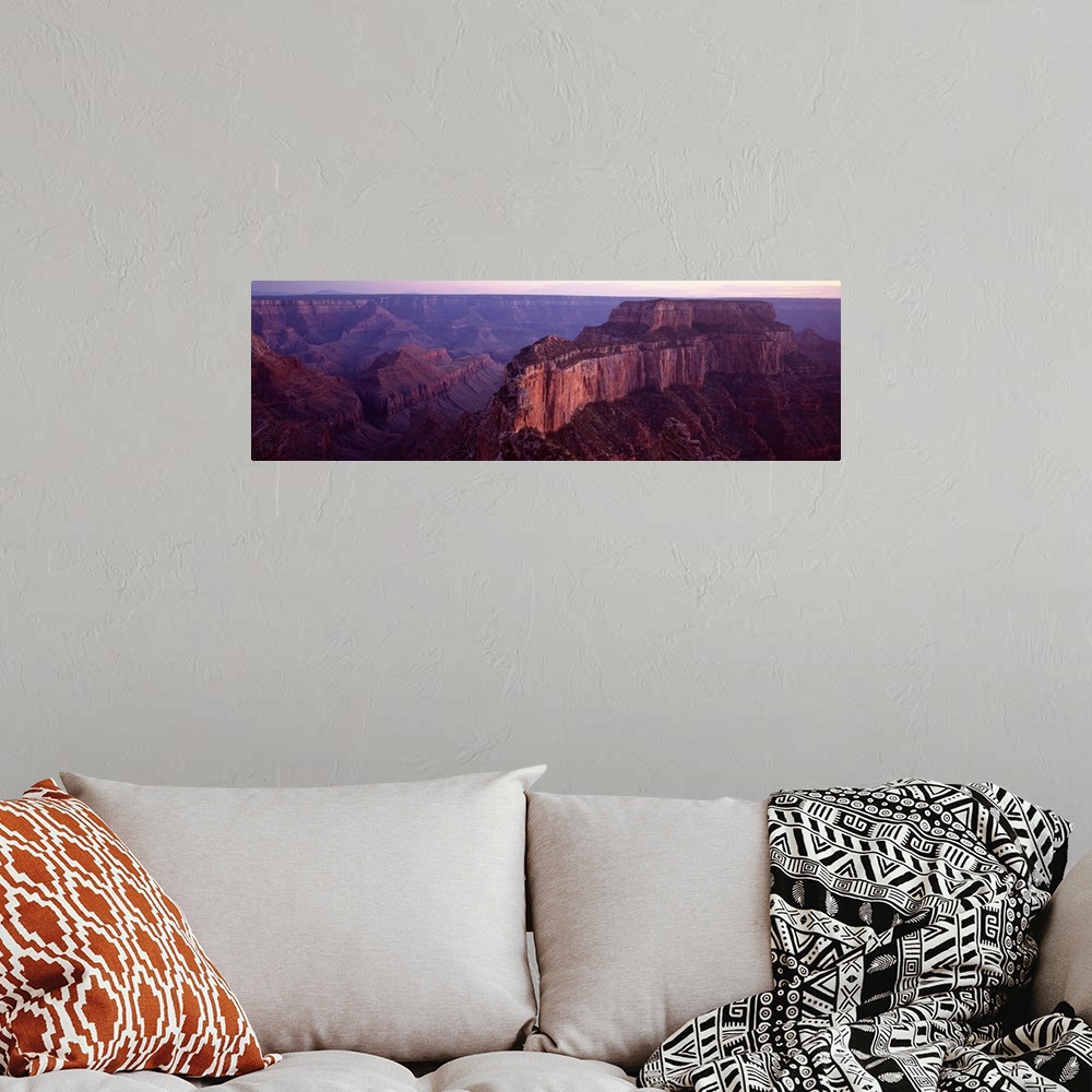 A bohemian room featuring This aerial wide angle shot is taken of the vast Grand Canyon during dusk and only a sliver of th...