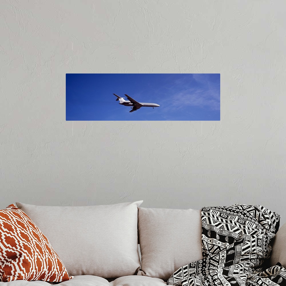 A bohemian room featuring Low angle view of an airplane flying, Tupolev Tu-154