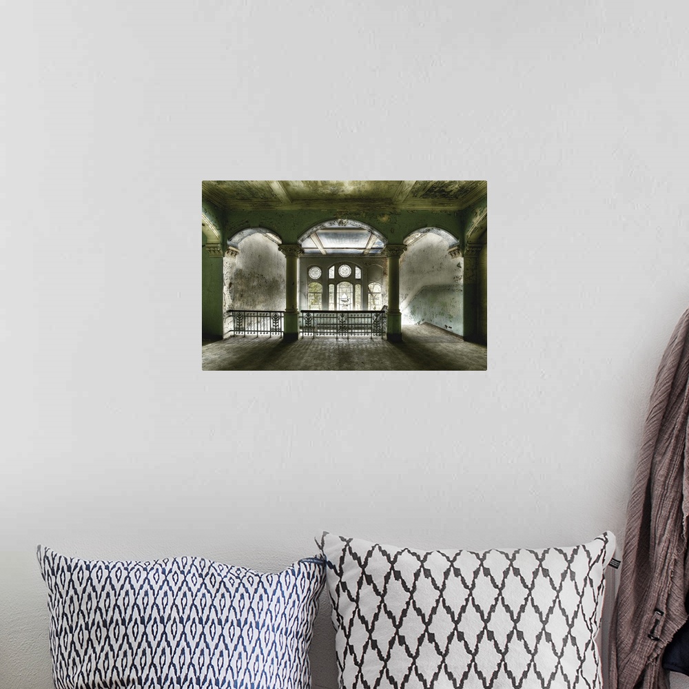 A bohemian room featuring Interior photograph of an abandoned building that has beautiful arches which welcome the daylight...