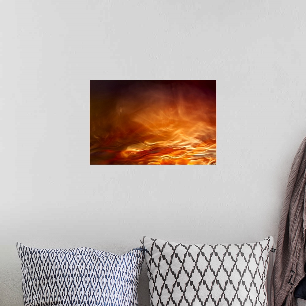 A bohemian room featuring Abstract digital art with orange, yellow, and red hues resembling water on fire.