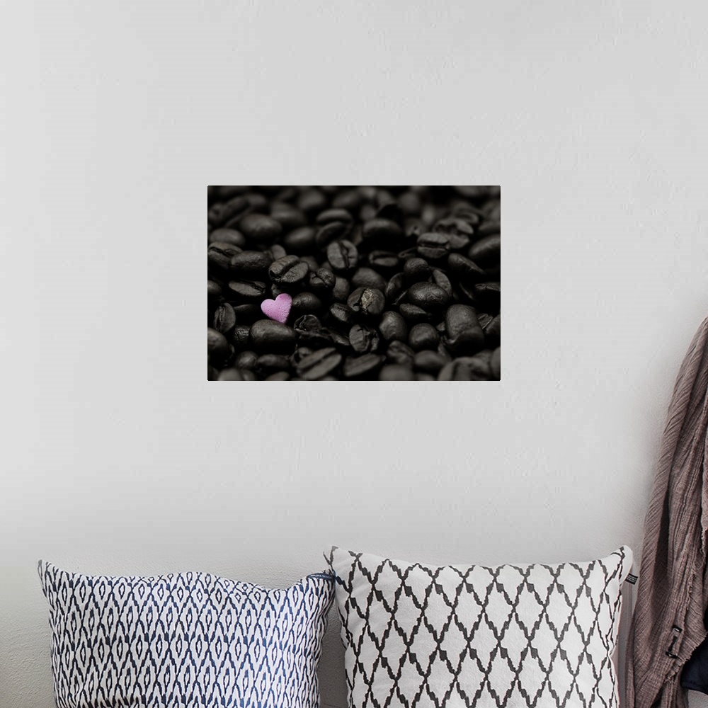 A bohemian room featuring Close-up photograph of dark coffee beans and a single pink heart.