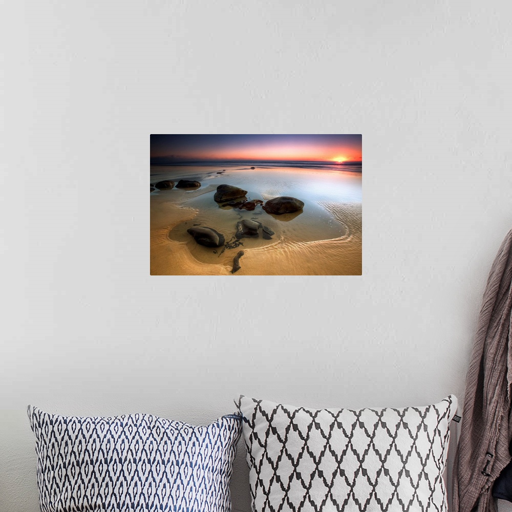 A bohemian room featuring Smooth rocks in low tide on Rainbow Beach, Queensland, Australia.