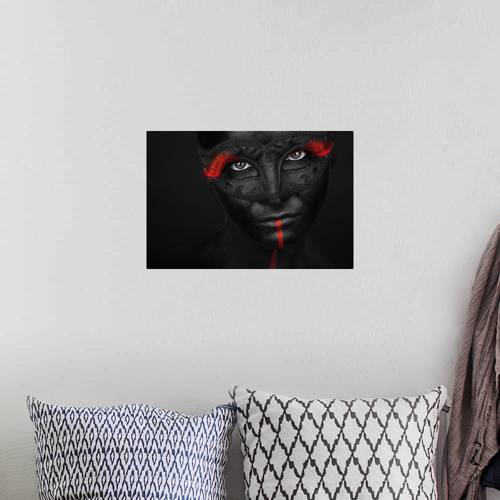 A bohemian room featuring Portrait of a model with black body paint and bright red eyelashes.