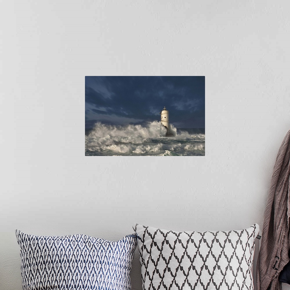 A bohemian room featuring Ocean waves crashing on a lighthouse in Calasetta, Province of Carbonia-Iglesias, Italy.