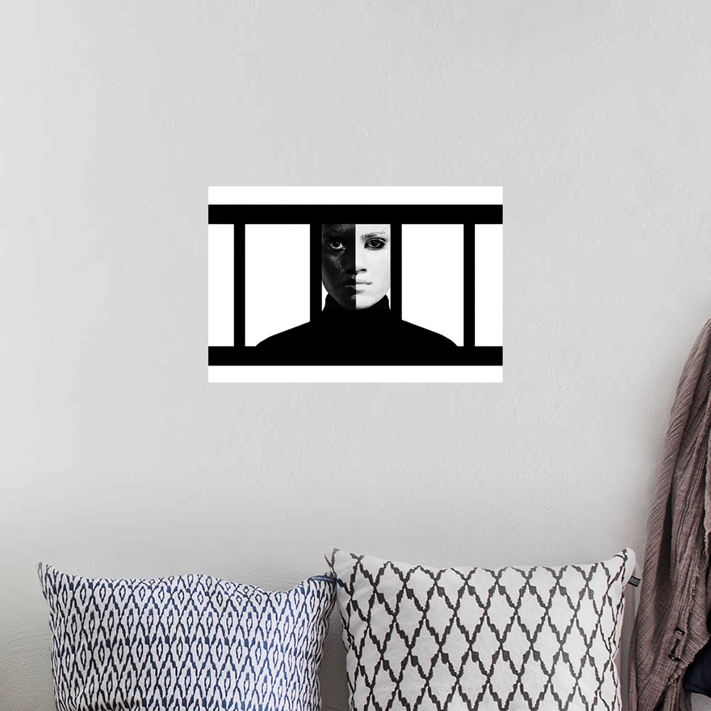 A bohemian room featuring A woman wearing makeup making her face exactly half black and half white, behind vertical bars.
