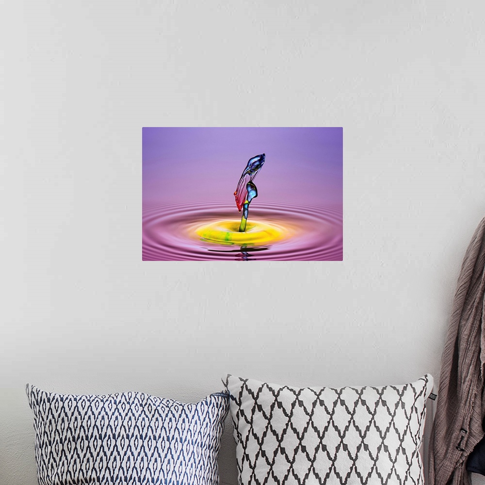 A bohemian room featuring A macro photograph of a drop of water caught suspended in mid-air against a vibrant colorful back...