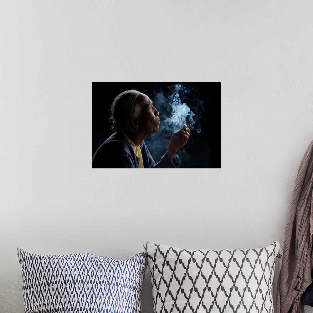 A bohemian room featuring A profile portrait of an old woman with smoke pouring from her mouth.
