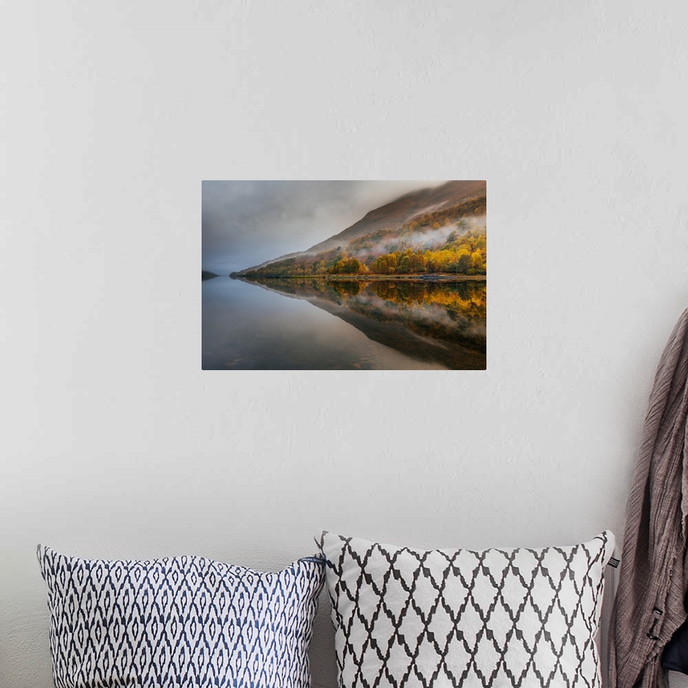 A bohemian room featuring Landscape photograph of reflective Autumn mountains with light fog on a lake.