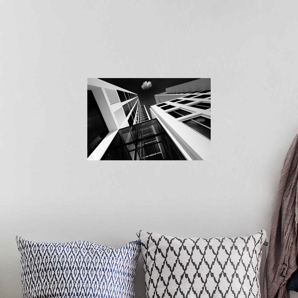 A bohemian room featuring A black and white photograph looking up at tall skyscrapers in Germany.