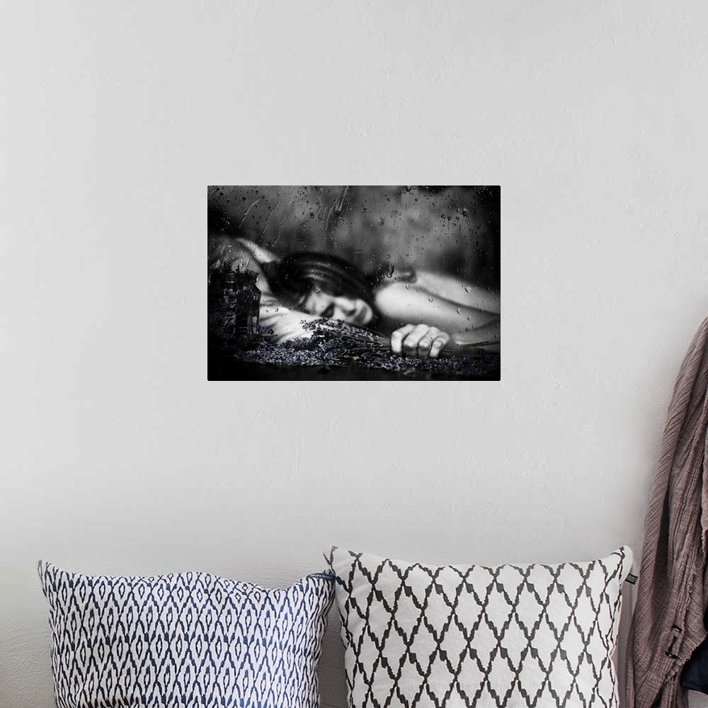 A bohemian room featuring Black and white image of a woman laying down with falling raindrops.
