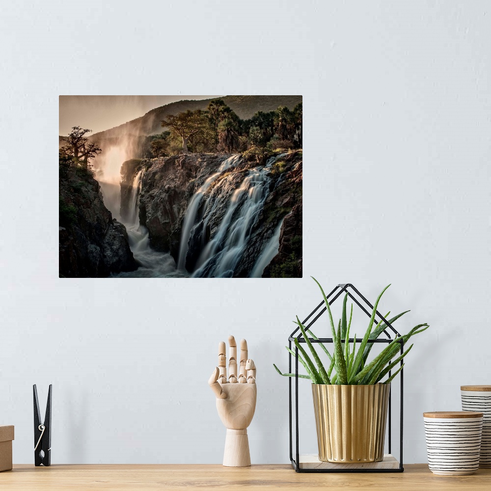 A bohemian room featuring Rushing waterfalls flowing over rocks cliffs in Africa.